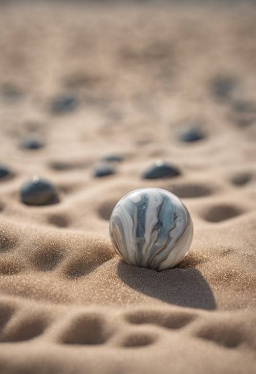 A close-up shot of a cool marble rolling down on a sandy beach