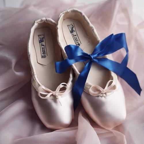 A pair of ballet shoes with blue silk ribbons tied around them.