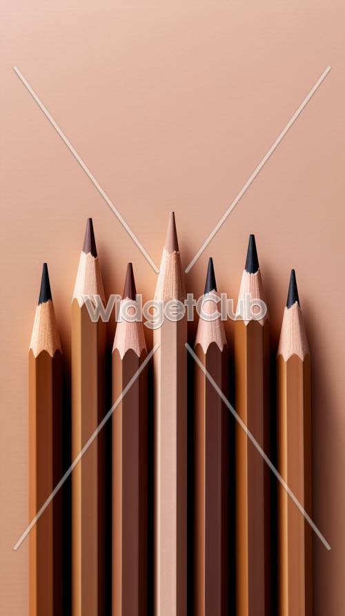 Crayons parfaitement taillés sur une surface rose pâle