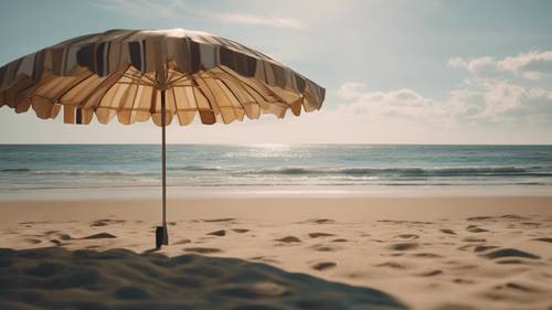 Uma cena estética de praia capturada sob a sombra de um guarda-chuva, ilustrando um dia sereno à beira-mar.