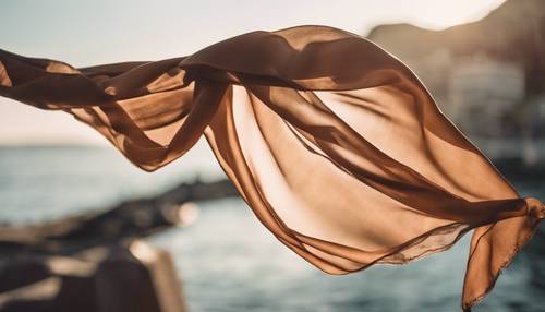 A brown, ombre, silk scarf floating in the wind on a sunny day. Wallpaper [4f561f9d604a4a29bc87]