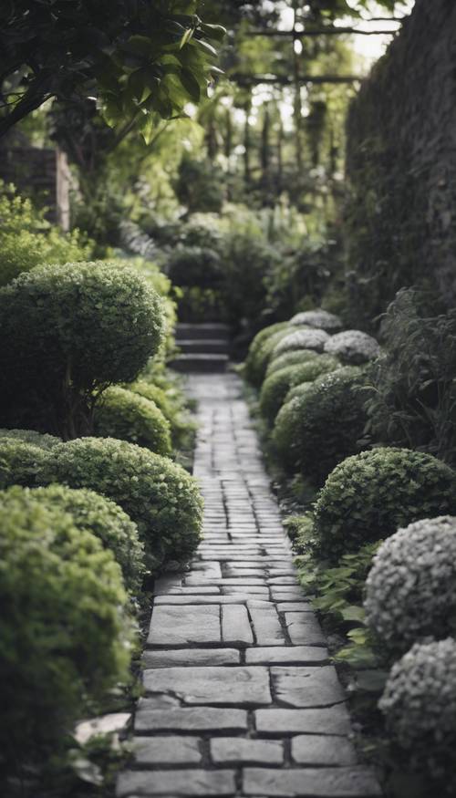 A black and gray brick pathway wandering through a lush garden.