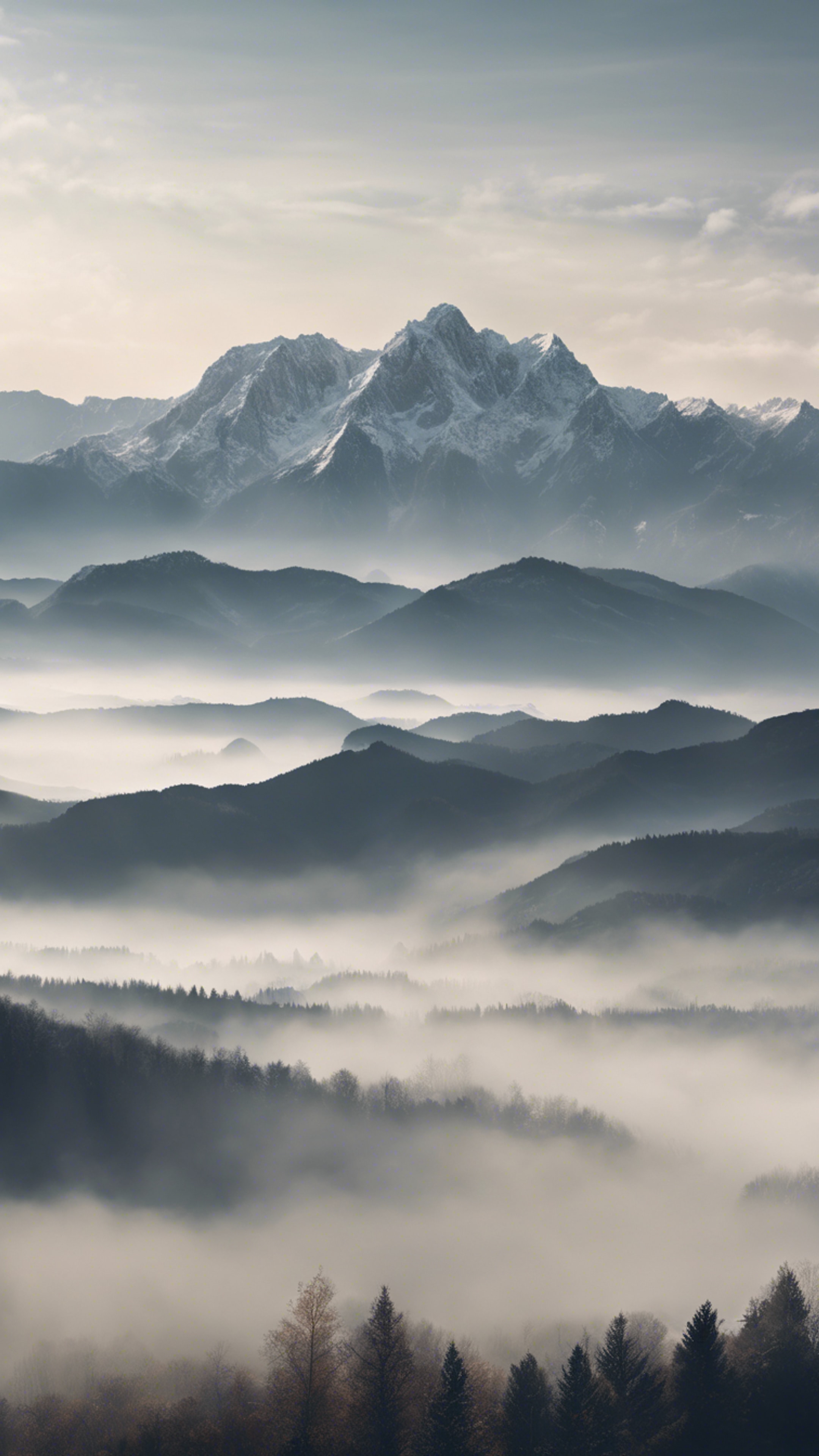 A panoramic view of a mountain range shrouded in mist. Hình nền[bb76ee600028486f9877]