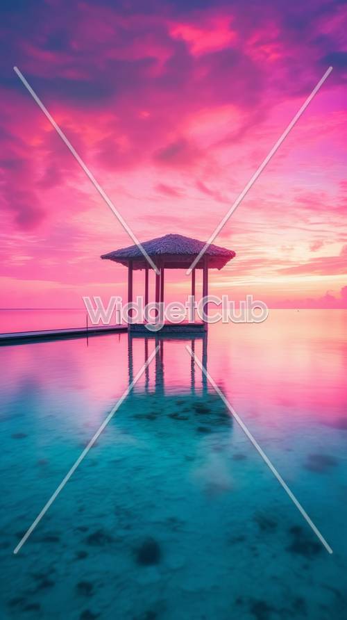 Różowy zachód słońca nad chatą nad tropikalnym oceanem
