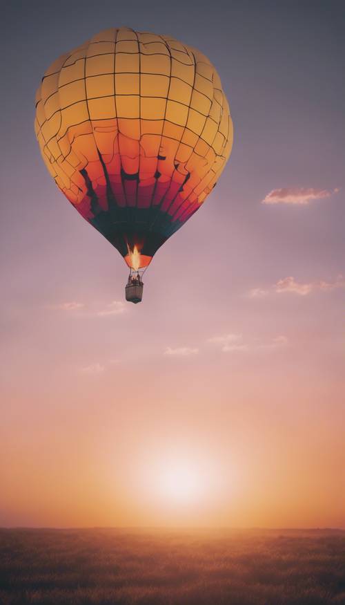 A hot air balloon rising in the sky during an intensely colored sunrise.