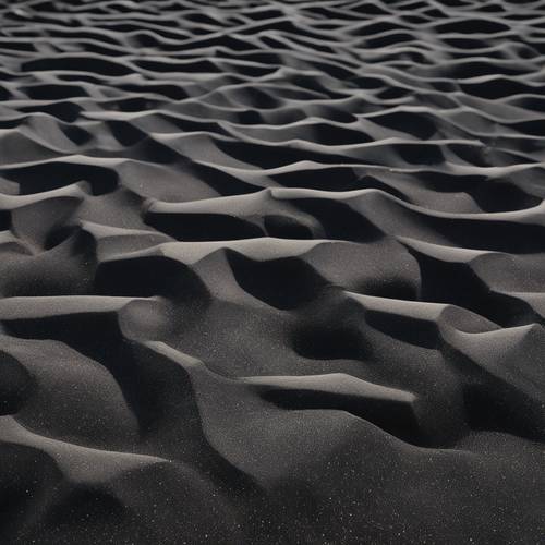 Areia preta organizada em arranjos geométricos precisos.