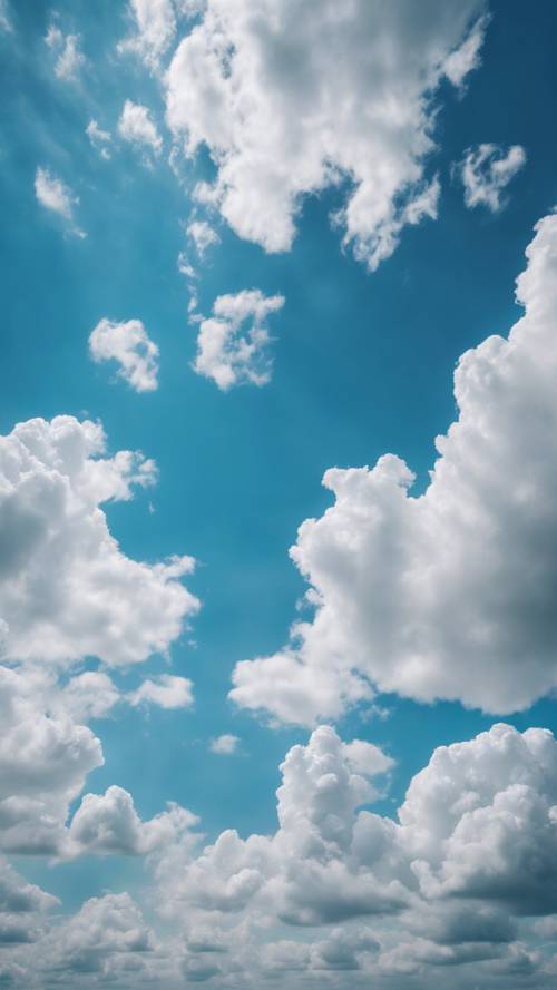 푹신한 흰 구름이 온통 흩어져있는 밝고 푸른 하늘.