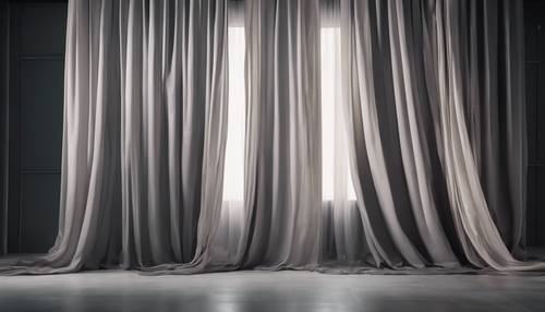A gray ombre fabric draping from ceiling to floor, moving from dark shadow gray at the top to a soft pearl gray at the bottom.