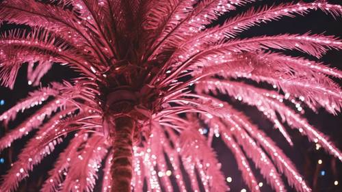 크리스마스 시즌 동안 줄기와 잎사귀를 따라 반짝이는 빛이 뿌려진 마법의 분홍색 야자나무입니다.