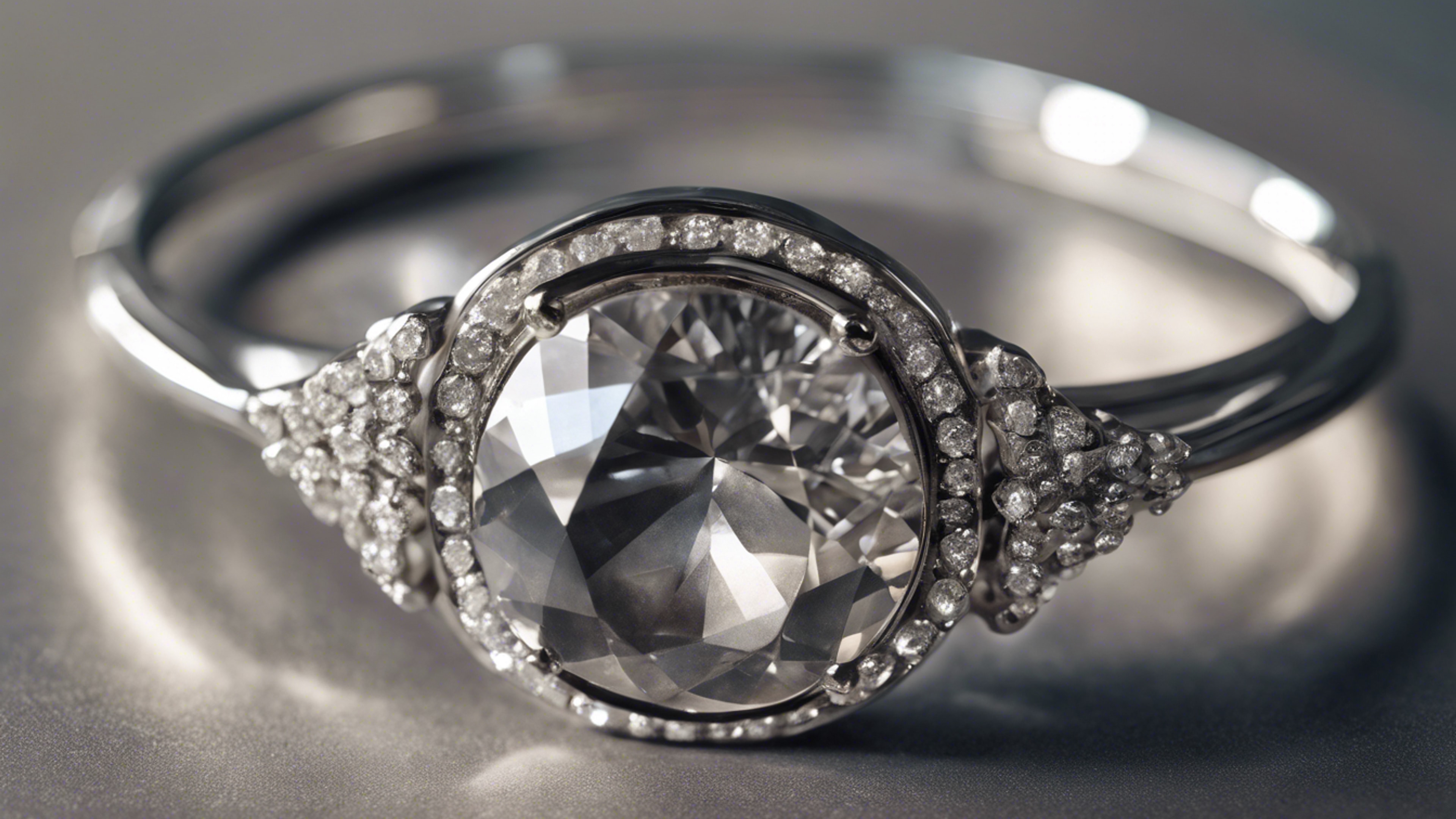 A gray diamond set in a modern, chunky silver bangle. Wallpaper[e0ba859bfe7e4f129e5d]