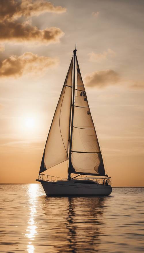 A white sailboat silhouetted against a golden sunset on the calm sea.