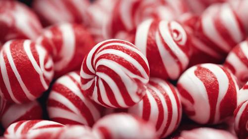 A detailed macro shot of a striped peppermint candy in vibrant red and white color.