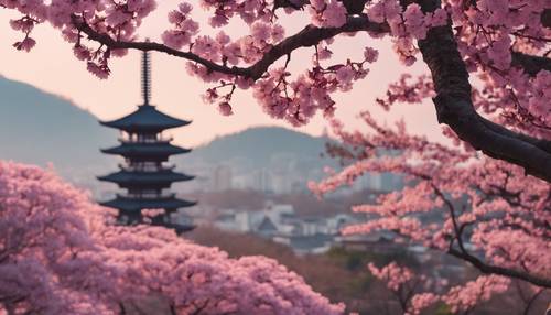 Pink plum blossoms against an ancient Japanese pagoda during dawn.