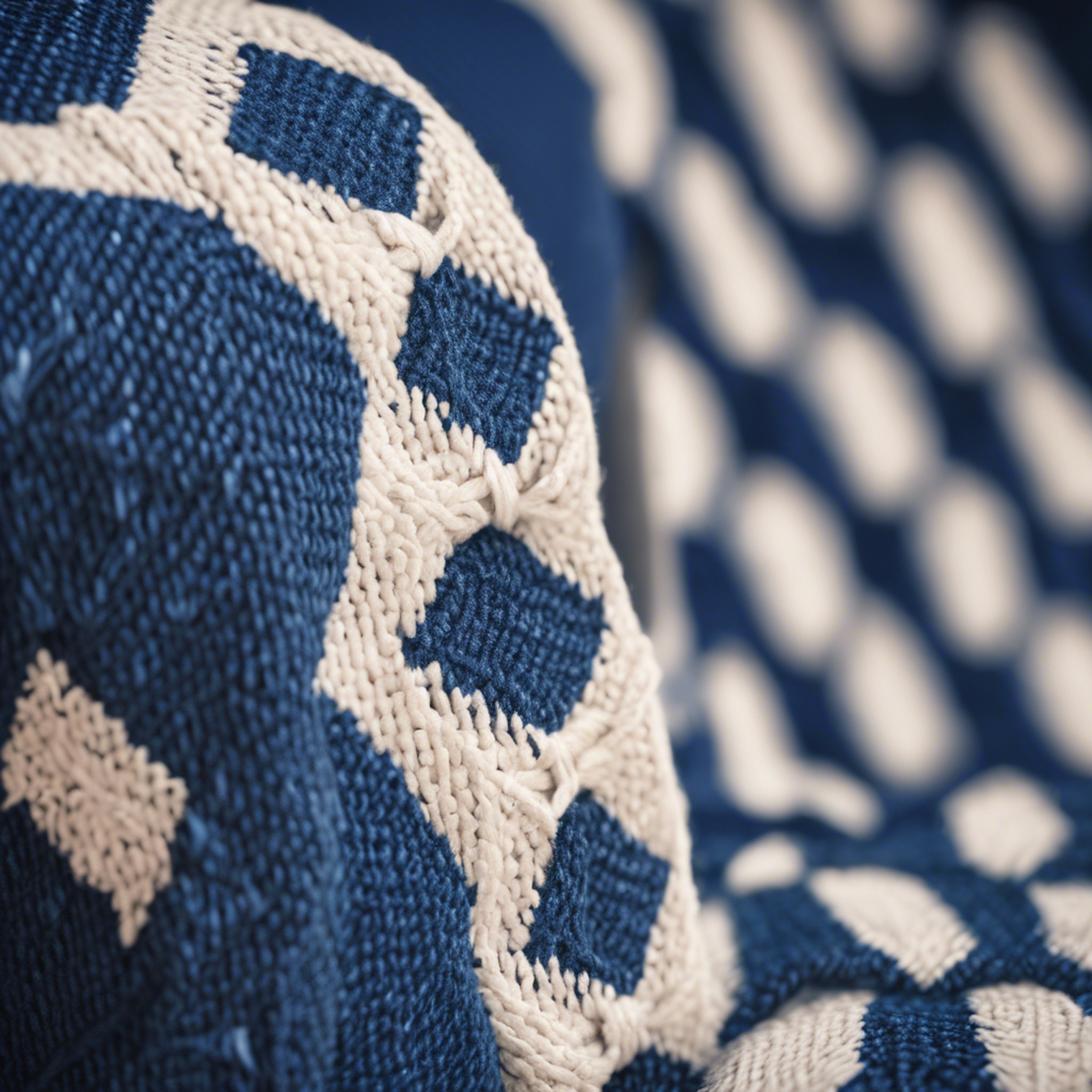 A close view of a preppy styled blue and white diamond-patterned sweater draped over a chair.壁紙[0af6246e15d04e86a483]
