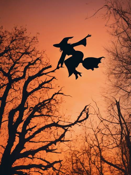 Siluet hitam seorang penyihir terbang melawan matahari terbenam bertema oranye, berapi-api, dan halloween.