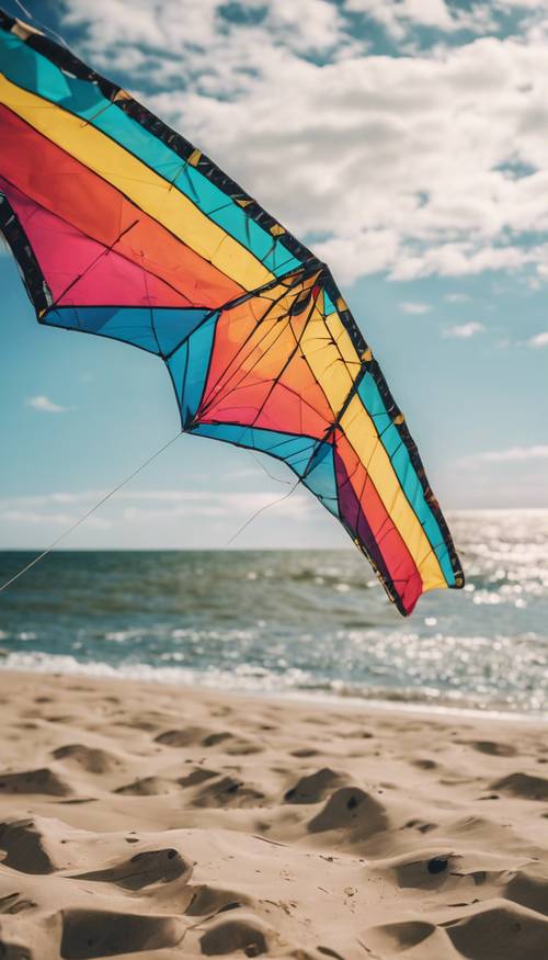 Una cometa colorida volando alto en el cielo junto al océano en un día brillante y ventoso de verano.