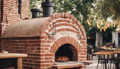 A rustic brick pizza oven at an outdoor artisanal restaurant.
