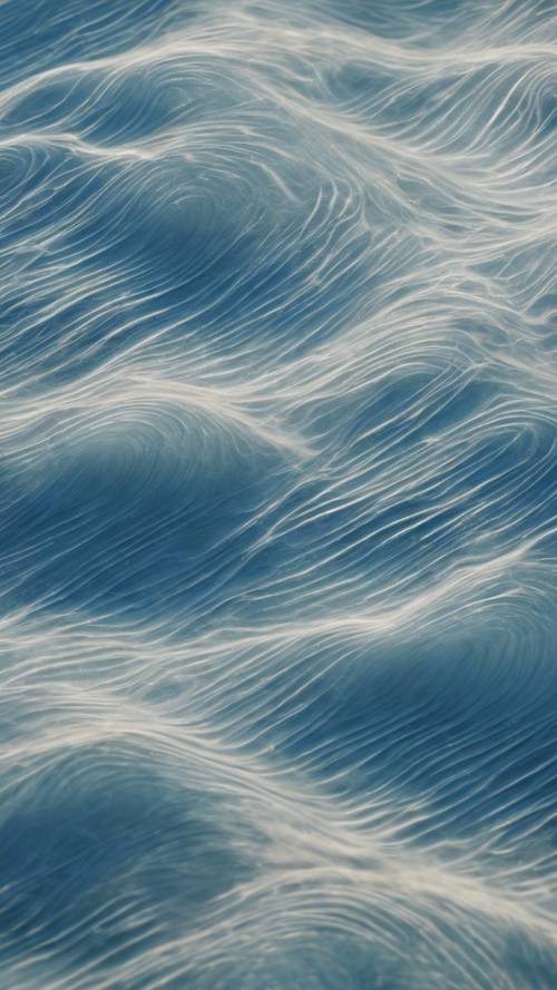 Overhead view of a windy blue plain, creating wave-like patterns on the surface.