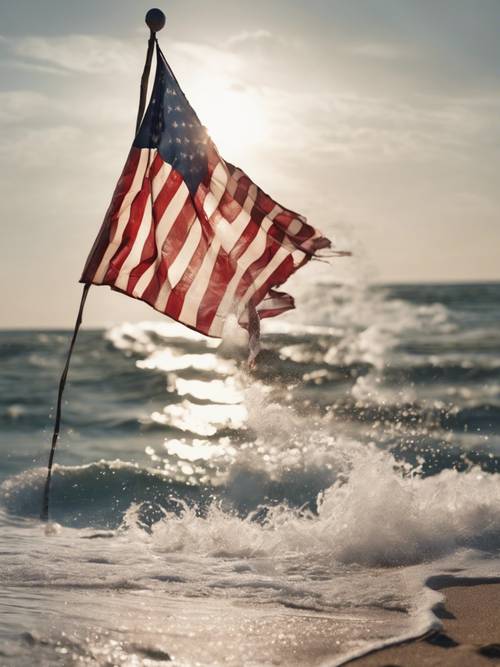Sóng vỗ vào bãi biển, với lá cờ Mỹ rực rỡ màu sắc tung bay trong gió biển mạnh.