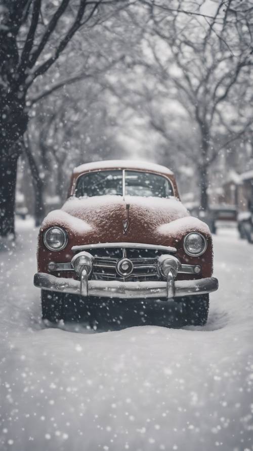 A vintage car covered in a blanket of snowflakes.
