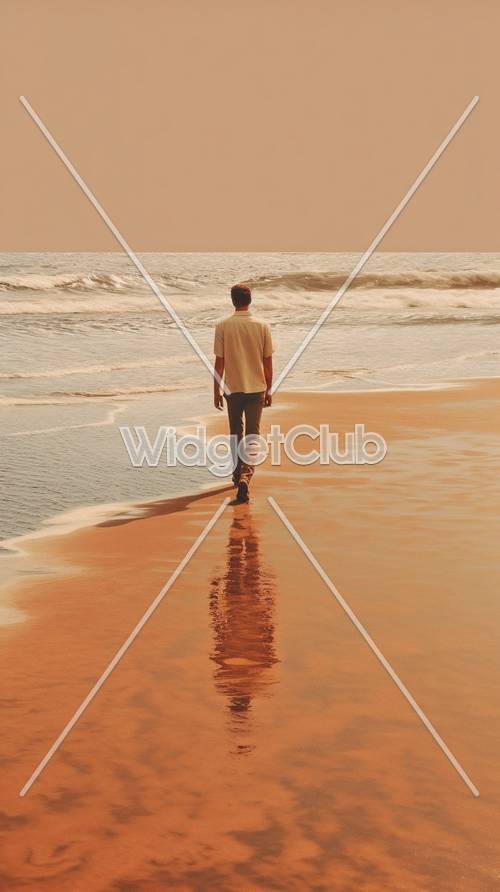 Homem caminhando à beira-mar ao pôr do sol
