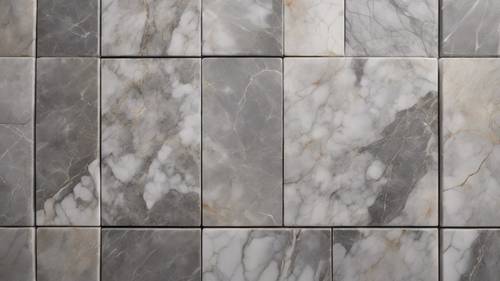 A polished square tile of gray marble used in a modern kitchen.
