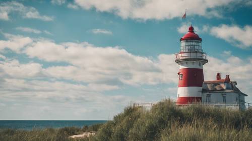 A lighthouse standing proud under a bold, mid-July blue sky.