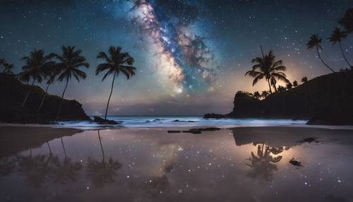 The twinkling night sky over a Hawaiian beach, with the milky way mirrored in a still water pool.