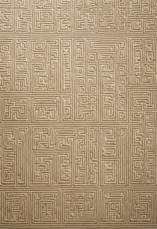 Intricate Greek key pattern on the edging of a cream-colored rug.