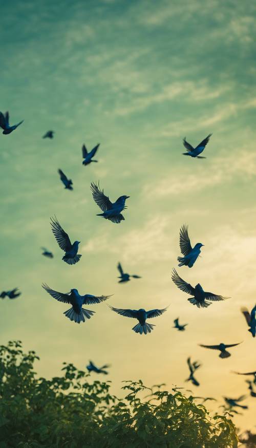 طيور زرقاء داكنة تحلق بحرية في سماء خضراء عند غروب الشمس.