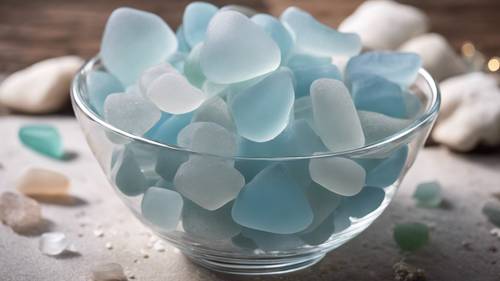 A collection of pastel blue sea glass displayed in a crystal bowl.