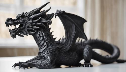 Un&#39;antica scultura in legno nero di un drago su un tavolo bianco e pulito.