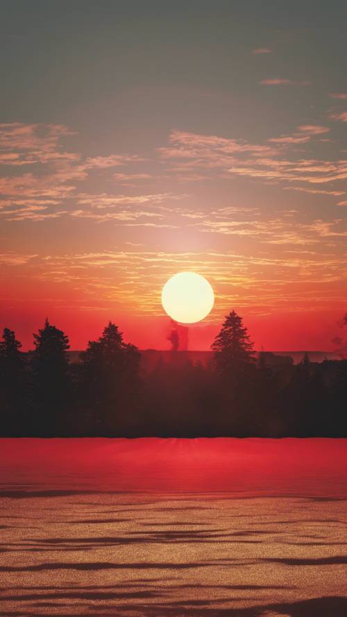Ein weitreichender Sonnenuntergang, bei dem leuchtend rote Strahlen nahtlos in einen hellen, gelben Horizont übergehen.