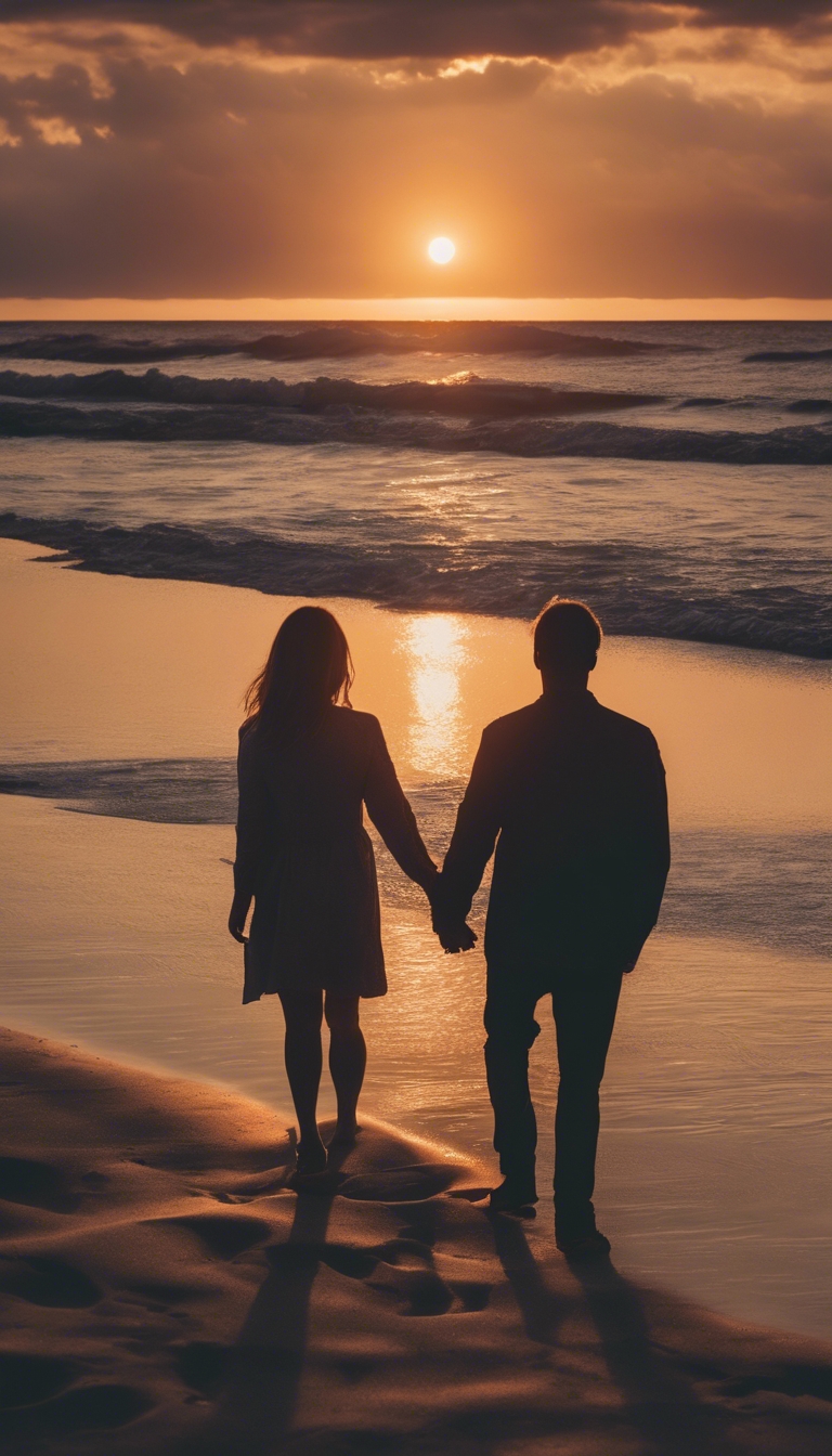 A couple's silhouette watching a beautiful sunset on a sandy beach, celebrating their first anniversary. Wallpaper[f3ca4807cc76413094f5]