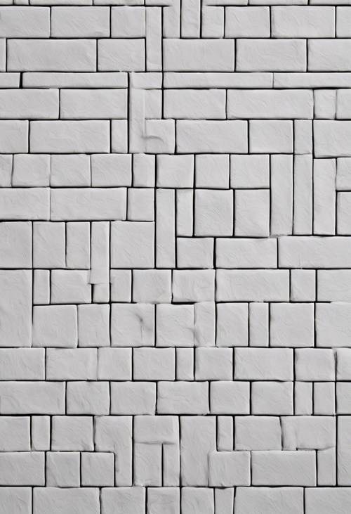 헤링본 스타일로 놓인 흰색 벽돌의 매끄러운 패턴입니다.