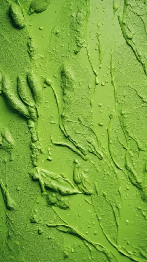 Pintura gruesa de color verde lima con textura manchada sobre un lienzo en un jardín botánico.