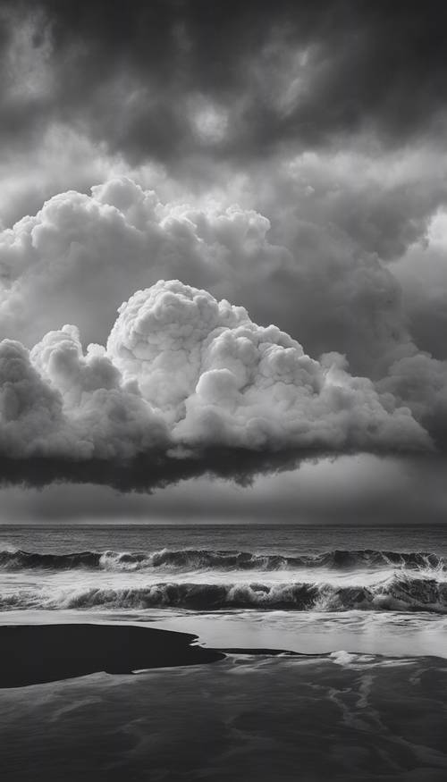 A dramatic black and white shot of a storm forming over the ocean.