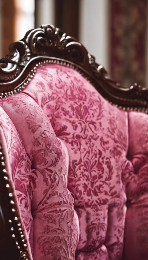 Close-up of a hot pink damask pattern on an antique chair.