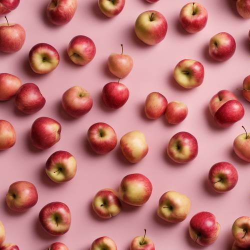 Multiple gala apples scattered randomly against a pastel pink canvas