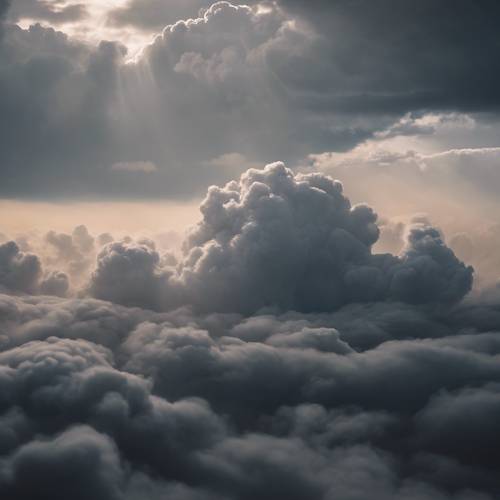 Des nuages doux, sombres et informes qui se fondent, créant un paysage flou et infini.