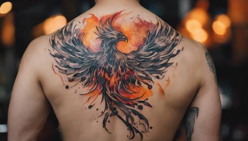 An abstract tattoo of a watercolor phoenix rising from ashes located on the back.