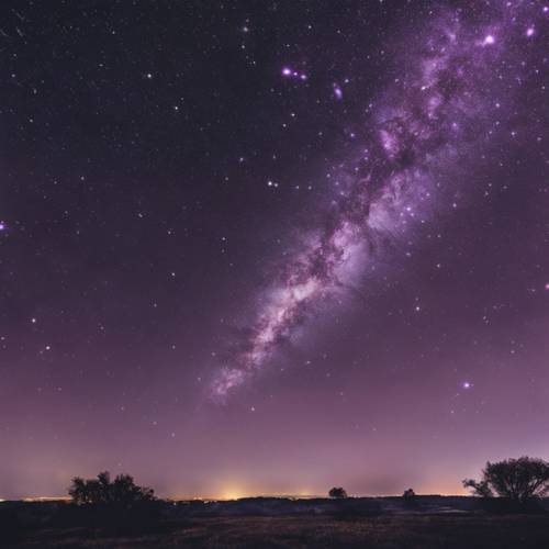 Long exposure shot of a light purple meteor shower lighting up the night sky.