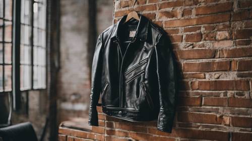 A patched up black leather jacket hung on a chair, signifying a resilient emo spirit.