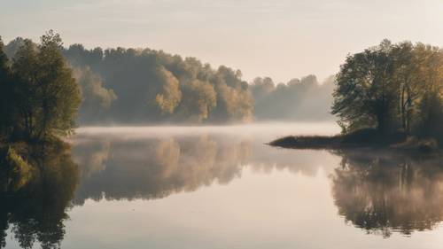 A September morning with mist rising from a calm lake