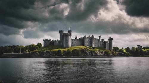 The Blackrock Castle in Cork, viewed from across the nature-filled grounds, under a dramatic stormy sky.