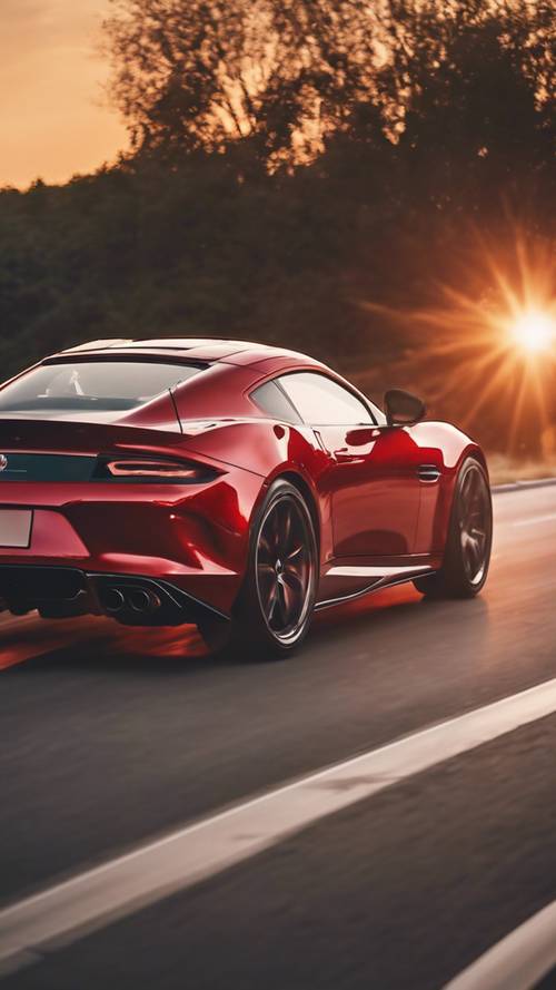 Un coche deportivo rojo brillante acelerando por la carretera con un fondo de puesta de sol.