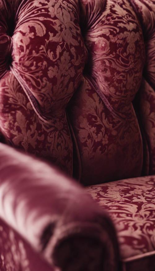 Close up of a burgundy damask upholstered Victorian sofa