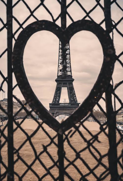 The Eiffel Tower seen through a heart-shaped hole in a fence.