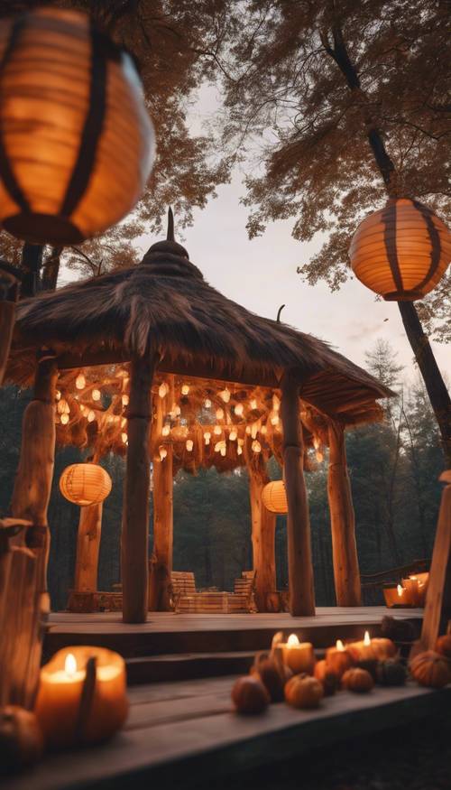 Glowing lanterns illuminating a beautifully-decorated Thanksgiving pavilion set in the middle of a forest during dusk.