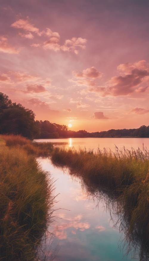 Un coucher de soleil vibrant avec un effet ombré pastel sur une rivière calme.